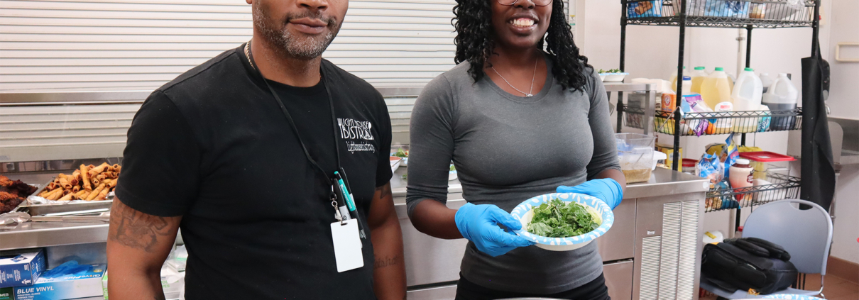 Light House staff and volunteer in community kitchen