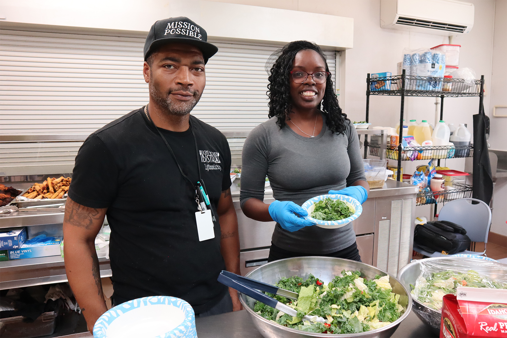 Light House staff and volunteer in community kitchen